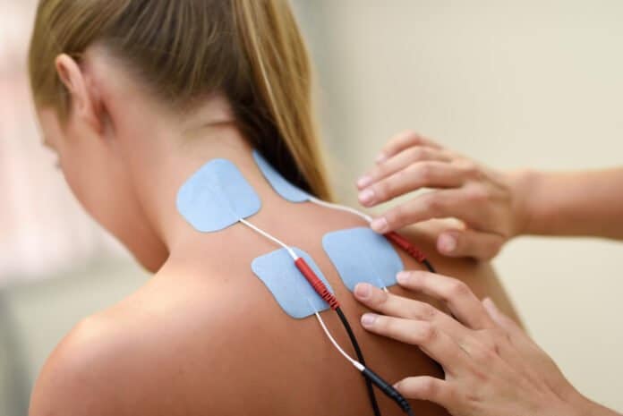 Electro stimulation in physical therapy to a young woman EMS